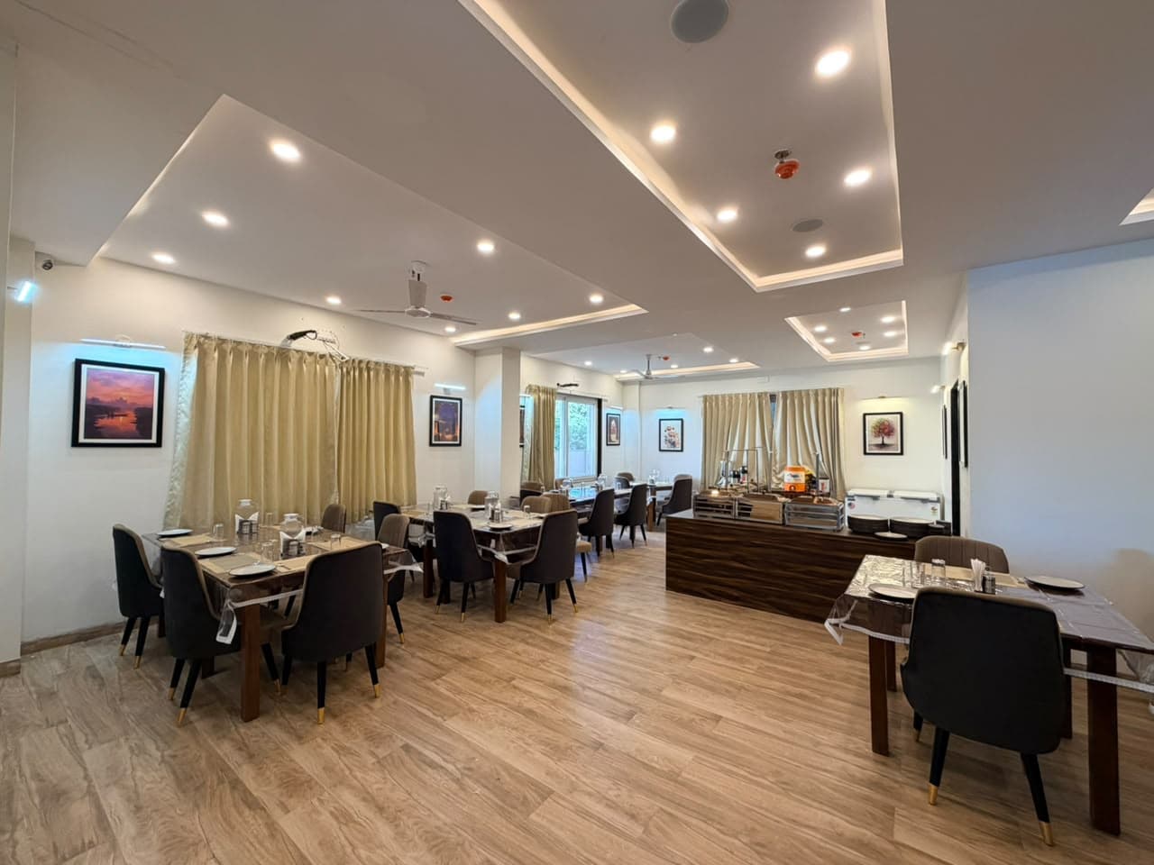Spacious vegetarian restaurant dining hall at Hotel Brick and Basalt in Udaipur